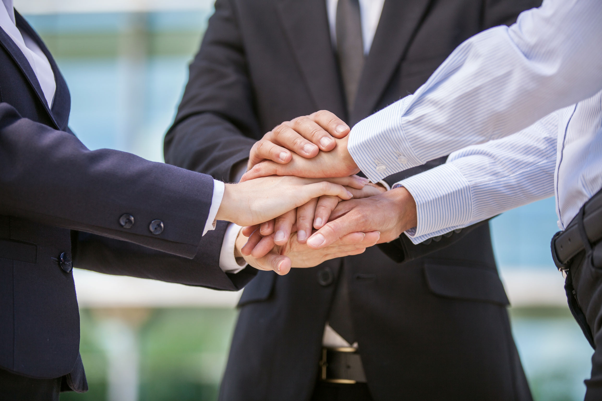 30866412 - closeup of business team holding hands together. close-up of three hands on top of each other